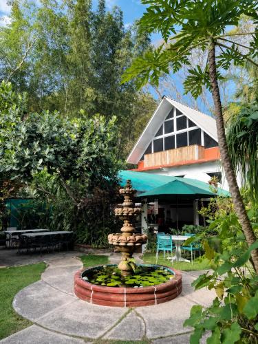 a fountain in front of a house with a building at Casa ANTAHKARANA in Puerto Vallarta