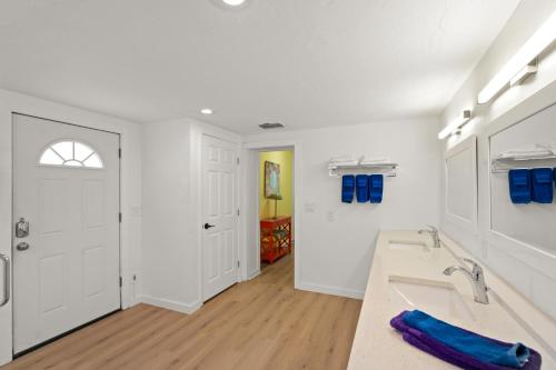 a white bathroom with a tub and a sink at Everglades Villa - Sleeps 8 - Walk to Siesta Beach in Siesta Key