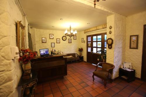 sala de estar con escritorio y ordenador. en HOTEL Quito Antiguo, en Quito