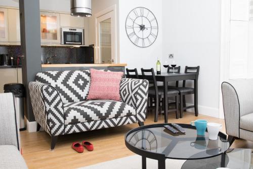 a living room with a couch and a table at Glenmoriston Town House Apartments in Inverness