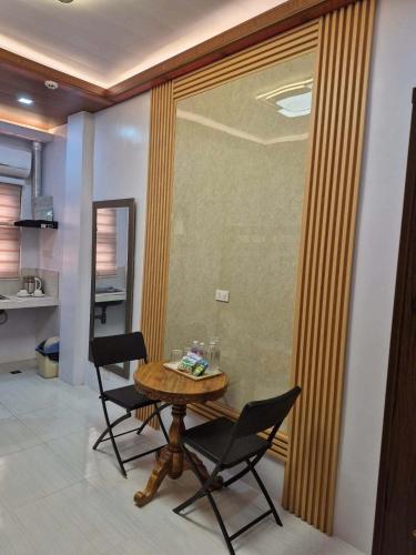 a dining room with a table and two chairs at Silid in Legazpi