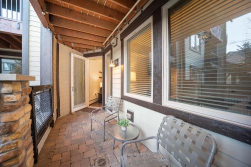 a porch with two chairs and a table and windows at Fraser Crossing 3309 in Winter Park