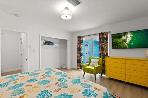 a bedroom with a bed and a tv on a wall at Everglades Villa - Sleeps 8 - Walk to Siesta Beach in Siesta Key