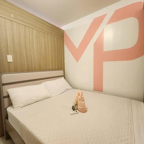 a bed with two dolls sitting on top of it at 1556 Shore Residences tower C - MOA in Sampong