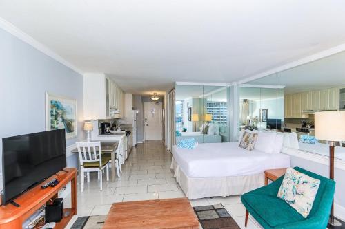 a bedroom with a bed and a living room at Ilikai Marina 987 in Honolulu