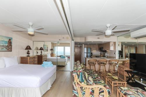 a bedroom with a bed and a kitchen and a living room at Ilikai Tower 1314 in Honolulu