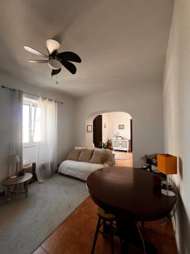 a bedroom with a bed and a ceiling fan at Santa Maria do Castelo in Sesimbra