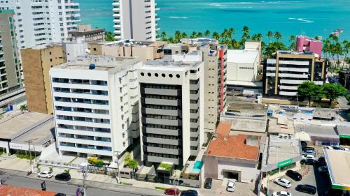 an aerial view of a city with buildings and the ocean at Top Unique Maceió in Maceió