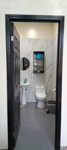 a bathroom with a toilet and a sink at Mi Tierra Surf City in El Majahual