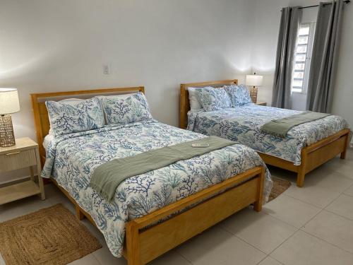 a bedroom with two beds with blue and white sheets at Luxury 3BR Villa Belair in Philipsburg