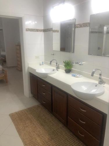 a bathroom with two sinks and a mirror at Luxury 3BR Villa Belair in Philipsburg