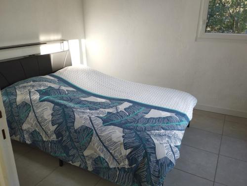 a bed in a room with a blanket on it at L'Uzerois in Uzer