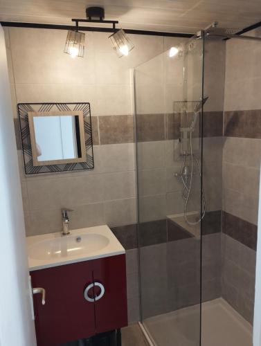 a bathroom with a sink and a shower at L'Uzerois in Uzer