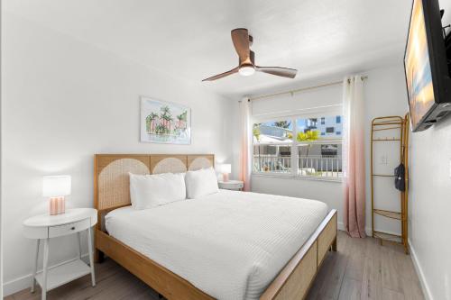 a bedroom with a white bed and a window at Hotel Cabana Clearwater Beach in Clearwater Beach