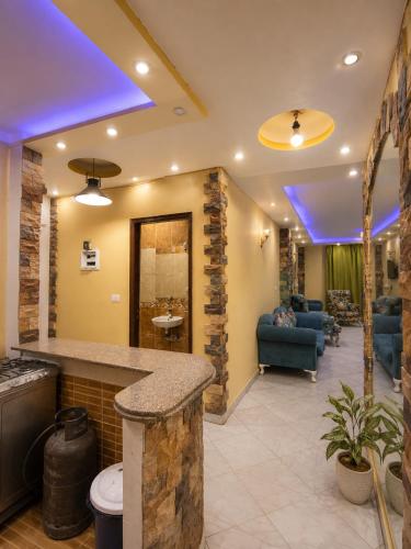 a lobby with blue lights on the ceiling at Hadayek Al-Ahram Guest House - حدائق الاهرام جيست هاوس in Giza