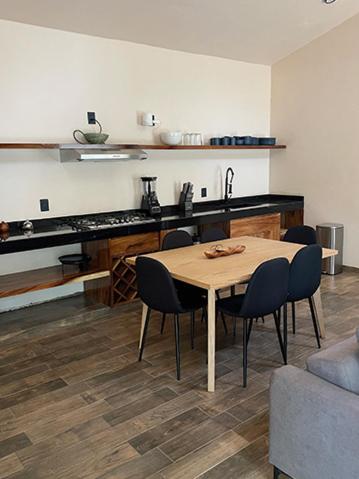 a kitchen with a table and chairs in a room at Soulchitlán in Suchitlán