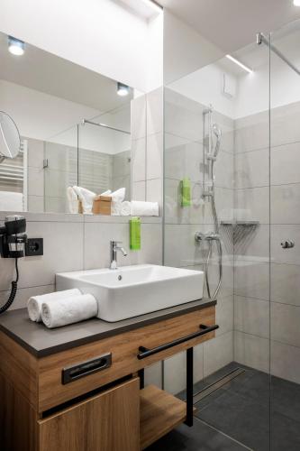 a bathroom with a sink and a shower at JUFA Hotel Werfenweng in Werfenweng