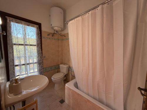a bathroom with a tub and a toilet and a sink at Athos Sea Villa in Ouranoupoli