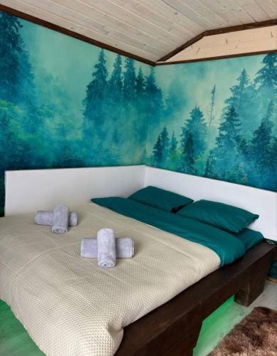 a bedroom with a bed with towels on it at FoxHome in Khashchovanoye