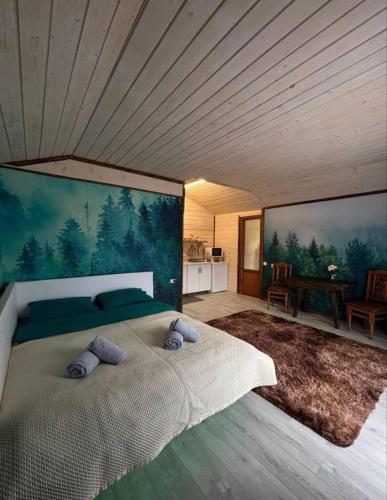 a bedroom with a bed with a painting on the wall at FoxHome in Khashchovanoye