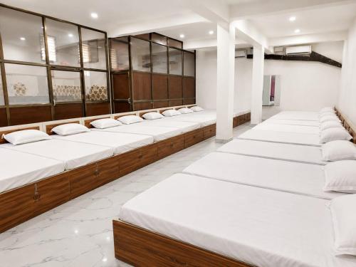 a row of beds in a dressing room at Hotel Eva Palace in Chatra