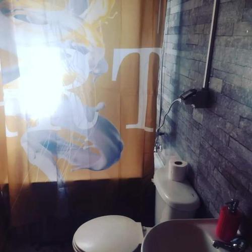 a bathroom with a toilet and a sink at Cabaña Bellavista in Cochamó