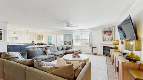 a living room with a couch and a tv at Rehoboth Beach - 24 Brooklyn Ave Unit E in Rehoboth Beach