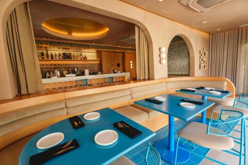 a restaurant with two blue tables and a bar at The Weekender Hotel in San Juan
