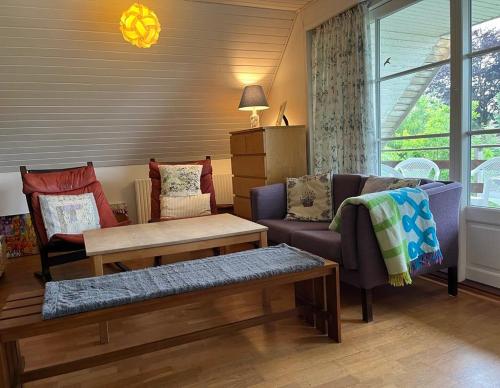 a living room with a couch and a table at Vestervang 1, 8654 Bryrup in Bryrup