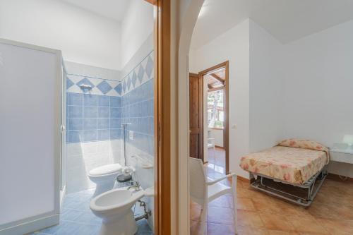 a bathroom with a toilet sink and a shower at Camping Villaggio Egad in Favignana