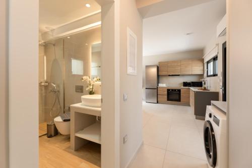 a bathroom with a sink and a toilet in a room at TATOLI Villas in Minia