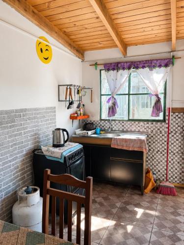 a kitchen with a sink and a stove and a window at Alojamiento EYO en Chuy con Baño Privado y Aire Acondicionado in Chuy