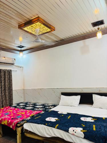 a bedroom with a bed with a blanket with cows on it at Maa chamunda dham in Mathura
