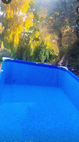 a blue swimming pool with trees in the background at Paradise in Monemvasia