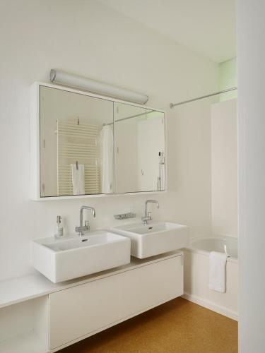 a bathroom with two sinks and a large mirror at Casa Navegna in Minusio