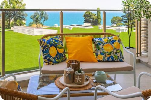 a porch with a couch and a table at Luxury Sea View Appartment with Beach Access - Parking & Heated Pool in Varna City