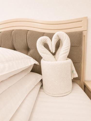 a bed with two swans shaped towels on it at Balea Events in Cîmpeni