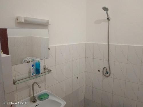 a bathroom with a shower and a sink at L'Urbain in Ziguinchor