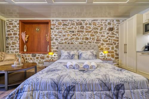 a bedroom with a bed with towels on it at Pietra Grand Suite in Nafplio