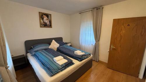 a bedroom with a bed with two towels on it at Alina in Graz