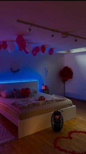 a bedroom with a bed in a purple room at Le jardin secret pool and spa in Lasne