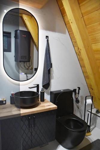 a bathroom with a black sink and a mirror at Magic Forest Durmitor in Motički Gaj