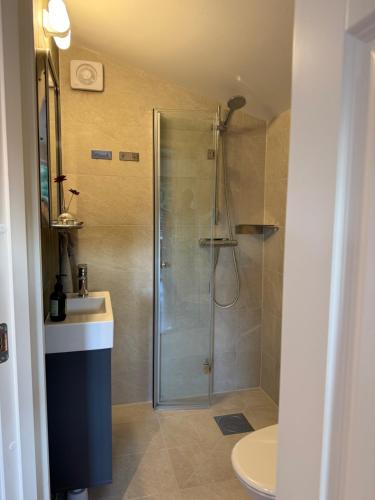 a bathroom with a shower and a sink at Stuga Marstrand in Marstrand