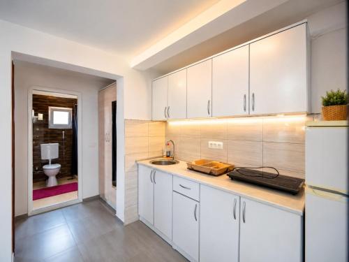 a kitchen with white cabinets and a sink at Apartments Leyla in Ulcinj