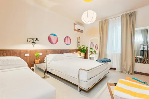 a bedroom with two beds and a window at CasaMichelin in Marina di Massa