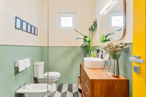 a bathroom with a sink and a toilet and a mirror at CasaMichelin in Marina di Massa