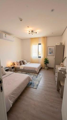 a large room with two beds and a couch at 3BDS Luxury Stay Apartment - شقة 3 غرف للإقامة الفاخرة in Jeddah