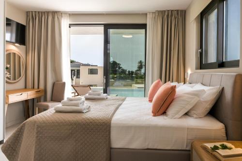 a bedroom with a large bed with a window at TATOLI Villas in Minia