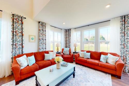 a living room with two red couches and a table at Bishop's Landing -- 31186 VICTOR RD in Millville