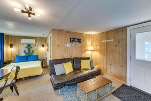 a bedroom with a couch and a bed and a table at Lakeside Reeds Spring Home w/ Deck & Pool Access! in Reeds Spring